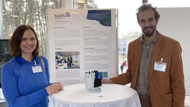 Dr. Iryna Okhrin and Dr. Peter Winkler (f.l.t.r.) standing in front of the ScaDS.AI stand at the event Innovationstreiber Künstliche Intelligenz in Sachsen
