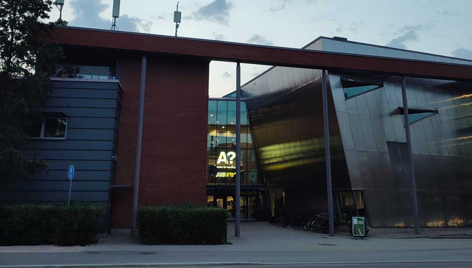 Image of the Computer Science Building at Aalto University, School of Science and Technology. A Brick Building witha modern metal coated extension.