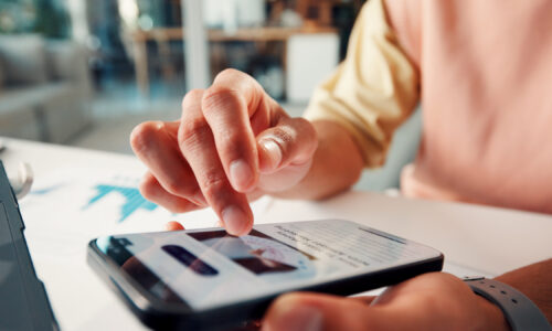Phone screen, hands and man in office with scrolling for blog post on affiliate marketing on mobile app. Cellphone, technology and closeup of employee on website for reading headline in workplace
