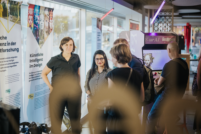 Dr. Verena Maleska and Marzan Tasnim Oyshi explaining FloodVis to guests at the opening of the exhibition "Explaining Artificial Intelligence" © Toni Kretschmer / Newpic Photography