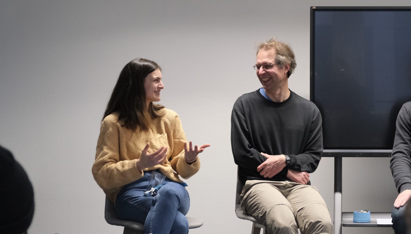 ScaDS.AI research associates Aruscha Kramm and Dr. Christian Martin laughing about funny experiences on their path to Data Science.