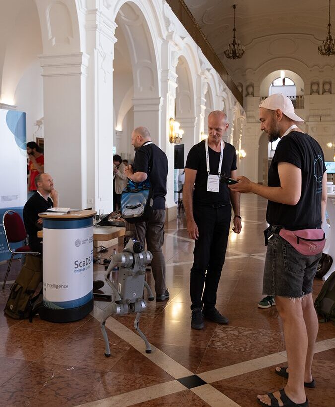 Photo. Johannes Häfner presenting the robot dog to a visitor of the Data Week 2025.