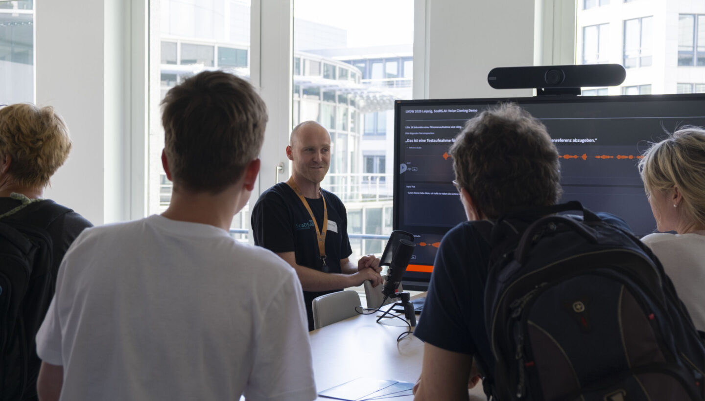 Photo. Oliver Welz shows visitors introduces visitors into 'Voice Cloning'.