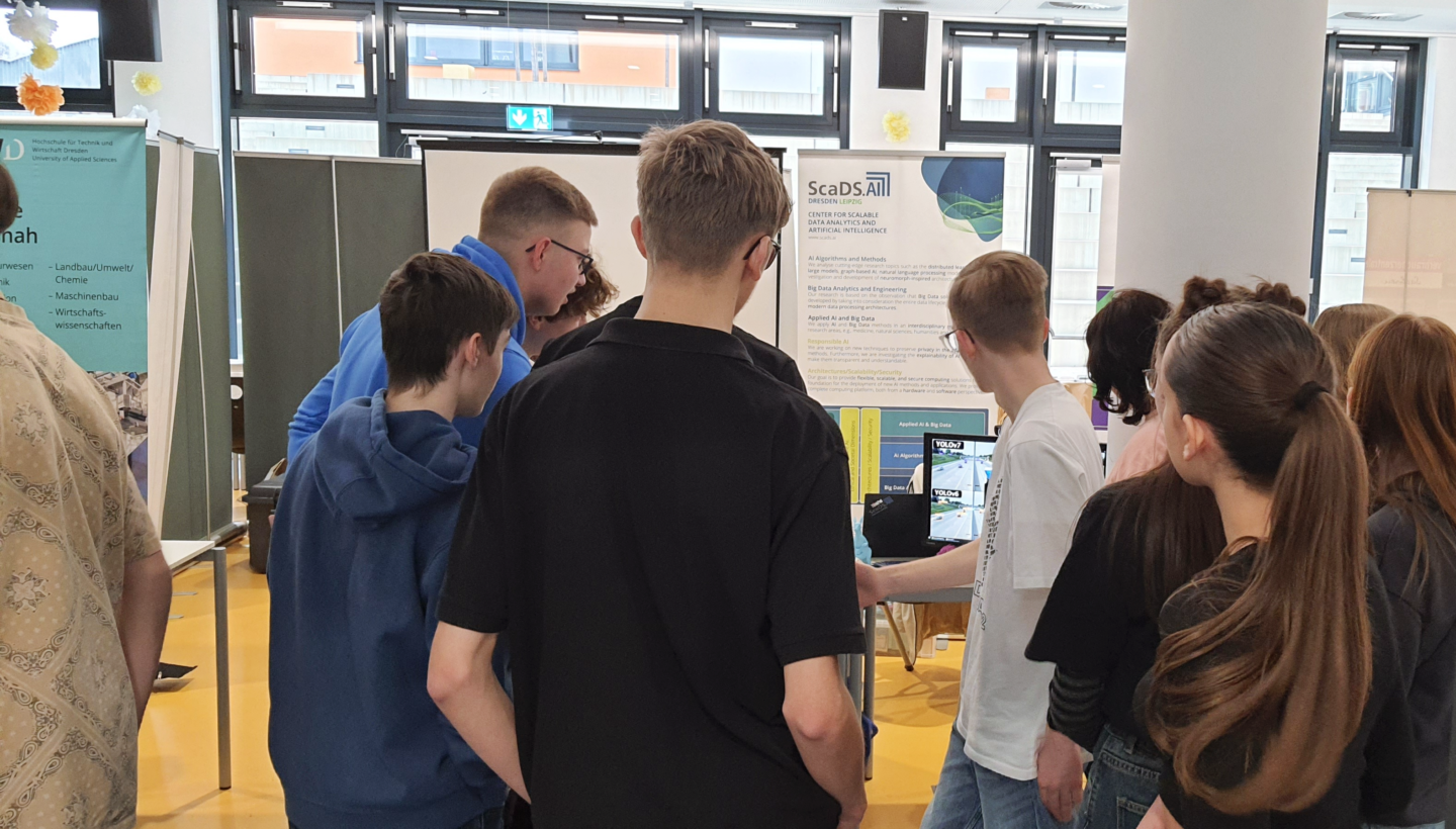 Pupils checking out the ScaDS.AI Dresden/Leipzig exhibit at Safer Internet Day 2024.