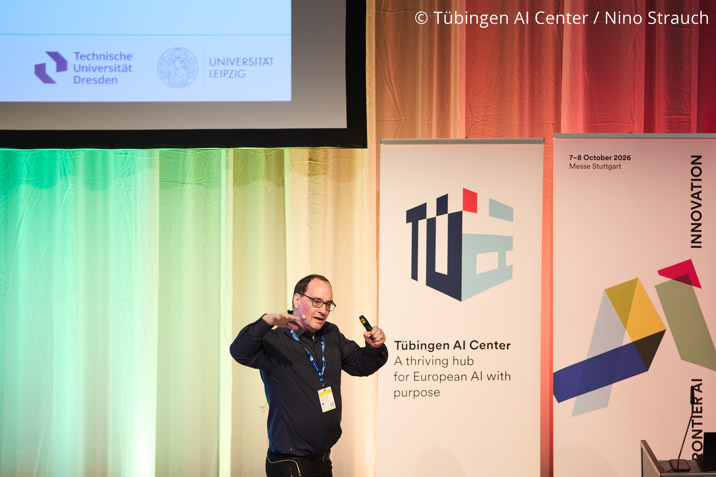 Photo. Prof. Dr. Gerik Scheuermann is giving the impact talk "Bridging Data, Knowledge, and Hardware: A Neuro-Symbolic Approach to Drug Discovery" at the Frontier AI Innovation Summit 2026. © Tübingen AI Center / Nino Strauch