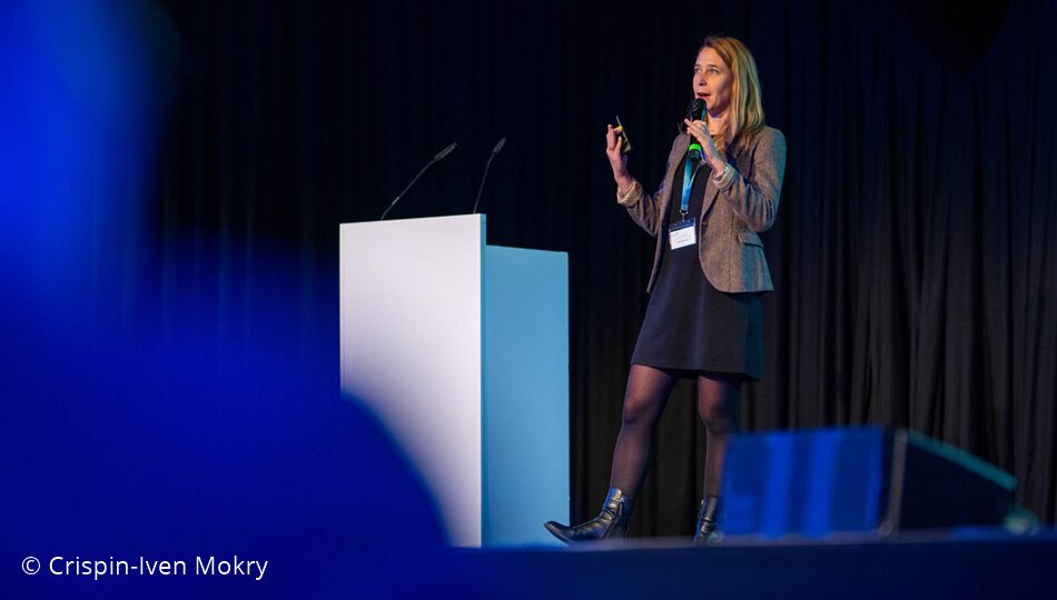 Photo. Laure Poirson presenting at the All Hands Meeting of the German AI Community in 2024. © Crispin-Iven Mokry