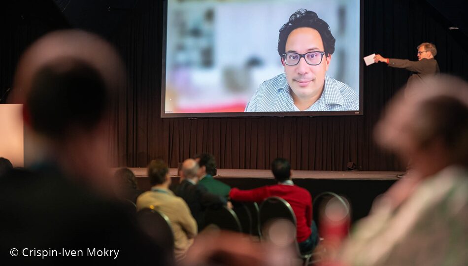 Photo. Prof. Aldo Faisal presenting at the All Hands Meeting of the German AI Community in 2024. © Crispin-Iven Mokry