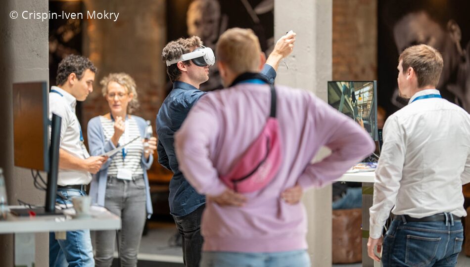 Photo. Demo Stations at the All Hands Meeting of the German AI Community in 2024. © Crispin-Iven Mokry