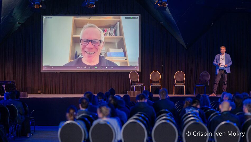 Photo. Prof. Dr. Nicholas Asher presenting at the All Hands Meeting of the German AI Community in 2024. © Crispin-Iven Mokry