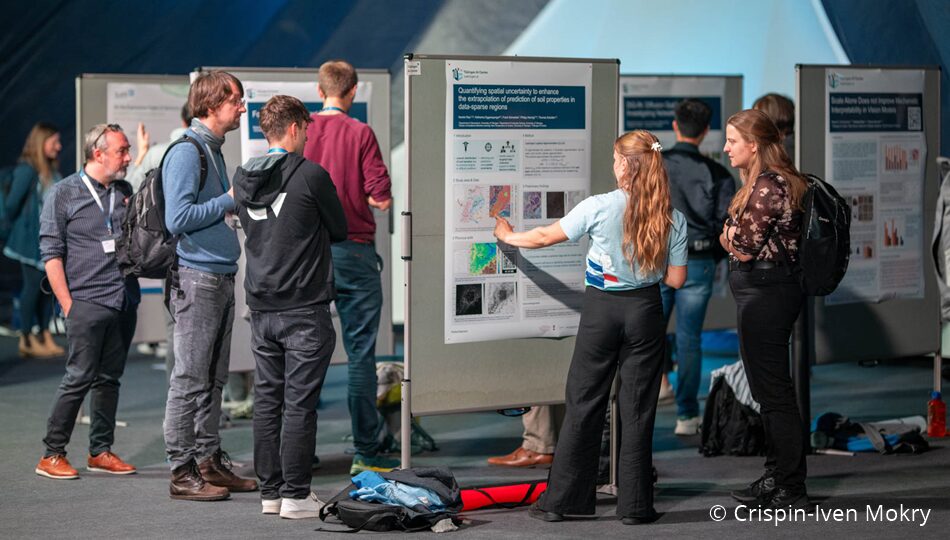 Photo. Participants interacting during the Poster Session. © Crispin-Iven Mokry