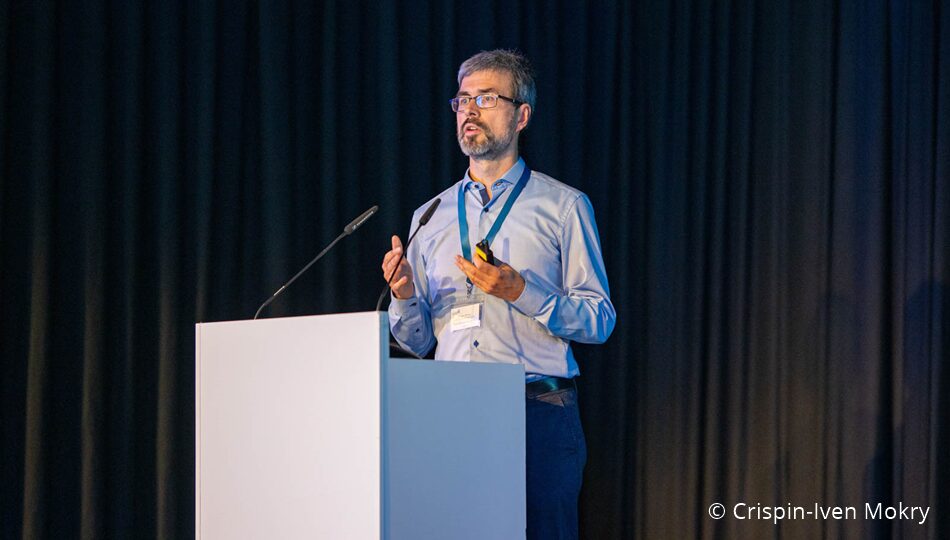 Photo. Prof. Dr. Markus Krötzsch presenting at the All Hands Meeting of the German AI Community in 2024. © Crispin-Iven Mokry