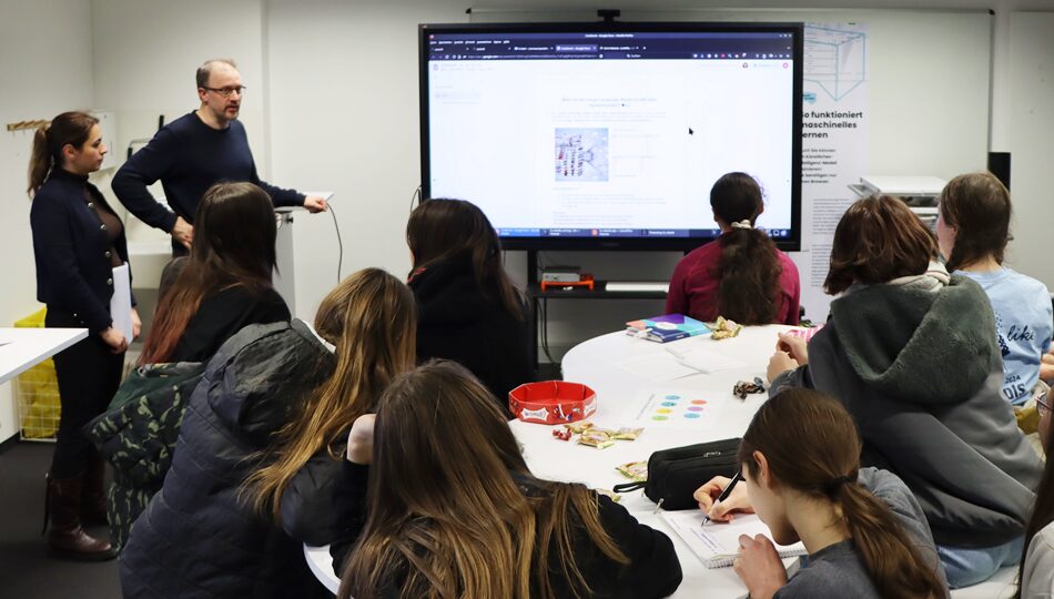 Photo. Prof. Sahar Vahdati and Prof. Jens Lehmann introducing pupils to the basics of Large Language Models at CeTI Girls for Robotos 2025 in the Living Lab in Dresden.