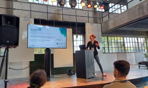 Photo. Lena Jurkschat is presenting the paper "Prompt Compression in the Wild: Measuring Latency, Rate Adherence, and Quality for Faster LLM Inference" at ECIR 2026.