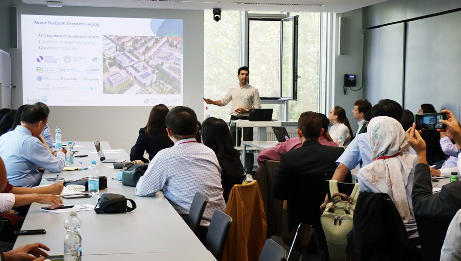 Photo. Dr. Siavash Ghiasvand is introducing ScaDS.AI Dresden/Leipzig to the Indian, Indonesian, and Vietnamese Delegation.