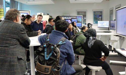 Photo. Dr. Christoph Lehmann explains a demonstrator to the Indonesian-German Graduate School.
