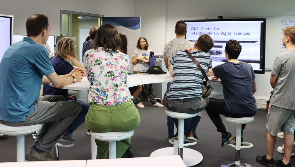 Photo. Dr. Iryna Okhrin introducting ScaDS.AI Dresden/Leipzig to the Living Lab visitors in June 2024.