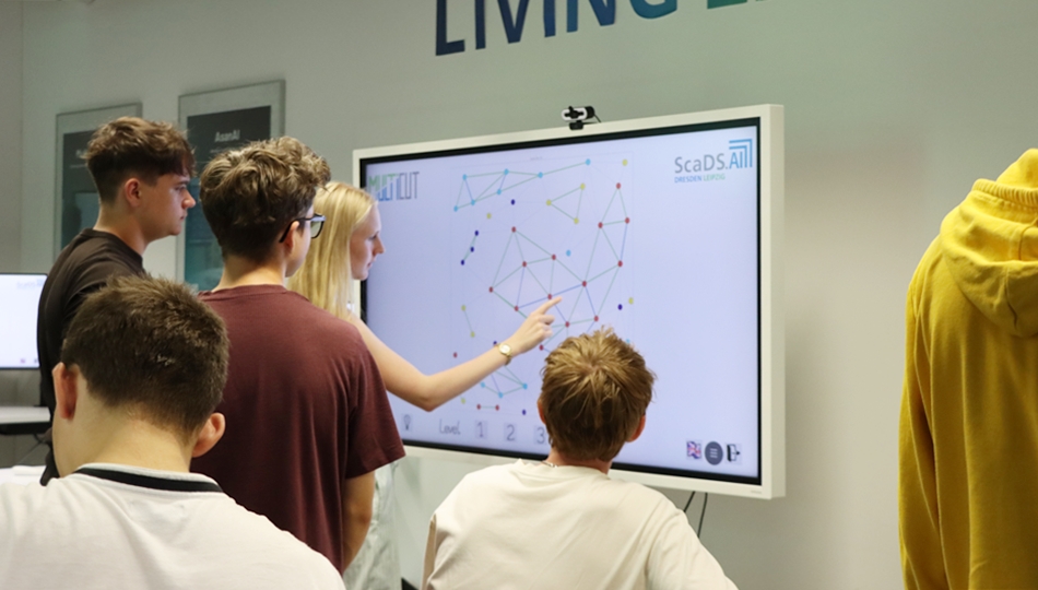 Photo. A group of pupils is playing the Multicut Game during Summer University 2026 at the Living Lab.