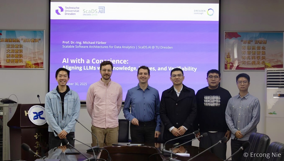 Prof. Michael Färber stands with five other researchers for a group photo in a university lecture hall after his presentation titled "AI with a Conscience: Aligning LLMs with Knowledge, Rules, and Verifiability" from TU Dresden and ScaDS.AI Dresden/Leipzig. © Ercong Nie