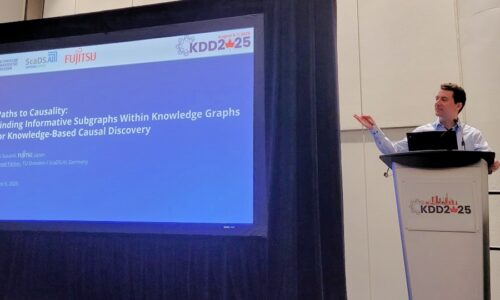 Photo. Prof. Dr.-Ing. Michael Färber presenting the paper "Paths to Causality: Finding Informative Subgraphs within Knowledge Graphs for Knowledge-Based Causal Discovery" at KDD 2025 in Toronto, Canada.
