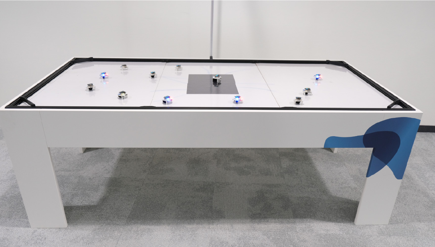 Large framed table that serves as an arena for the Dezibots.