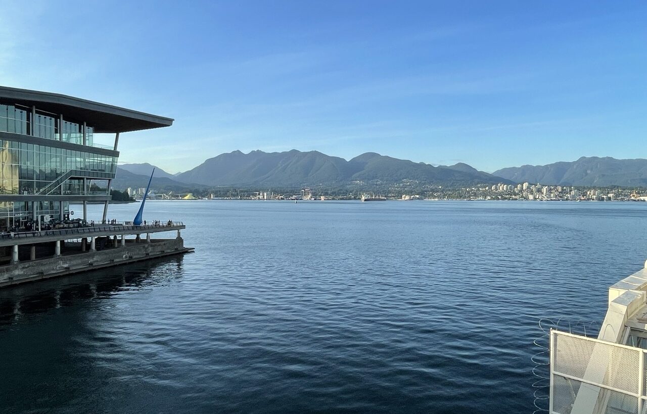 Photo. The exterior facade of the conference building with a view of the sea and mountains.