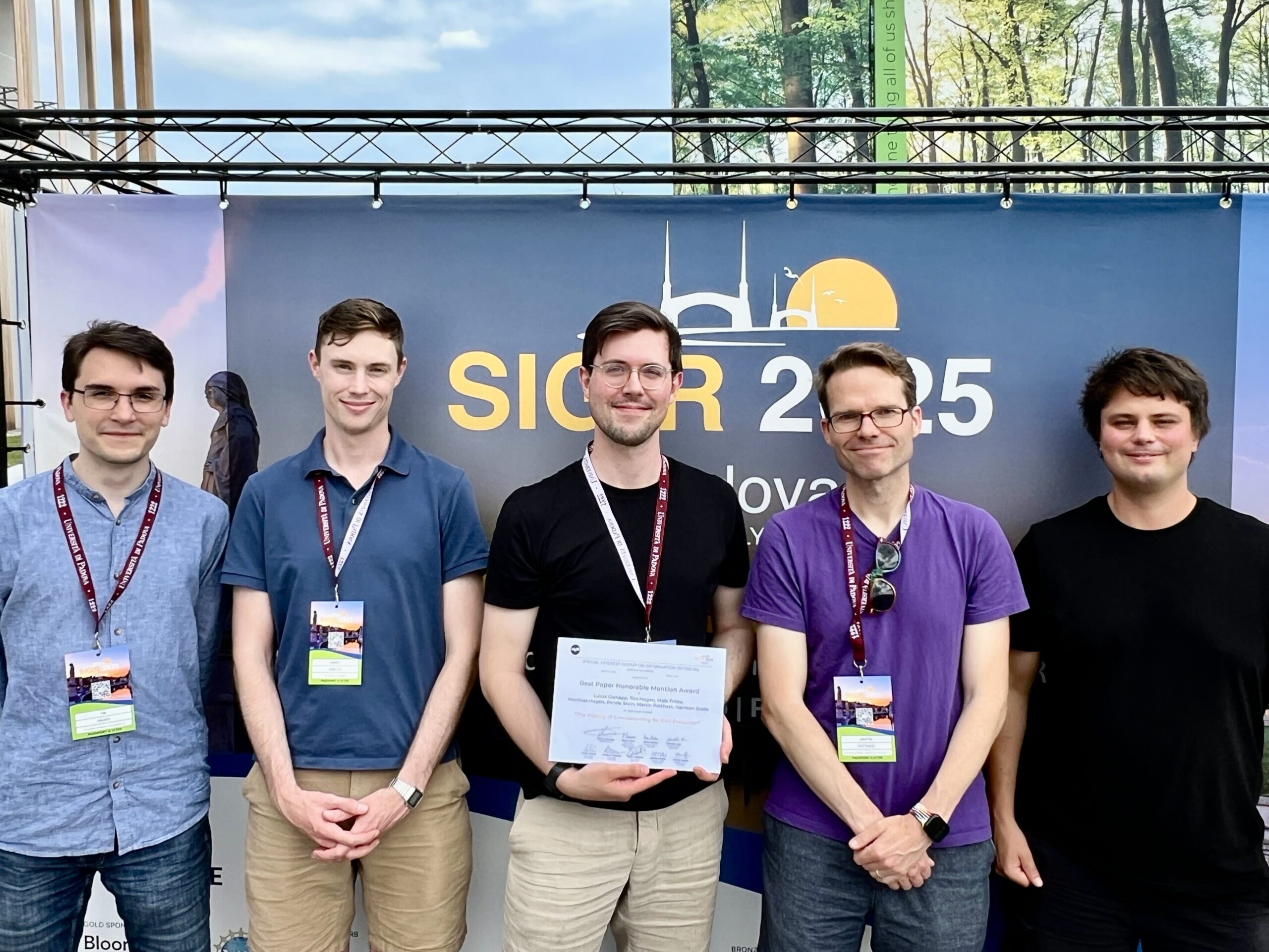 Photo. Group photo of the awardees of the Best Paper Honourable Mention Award at SIGIR 2025 (from left to right: Tim Hagen, Harrisen Scells, Lukas Gienapp, Martin Potthast, Maik Fröbe)